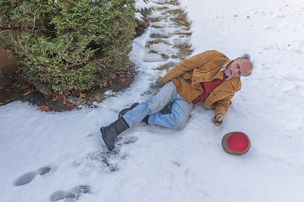 istock Senior man slipping on ice on his walkway 637247774