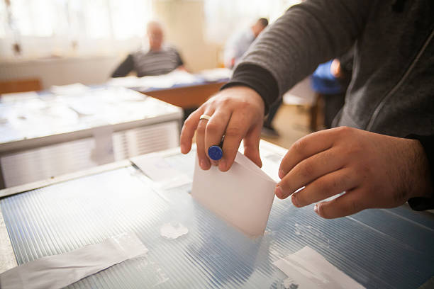 Person voting at polling station stock photo
