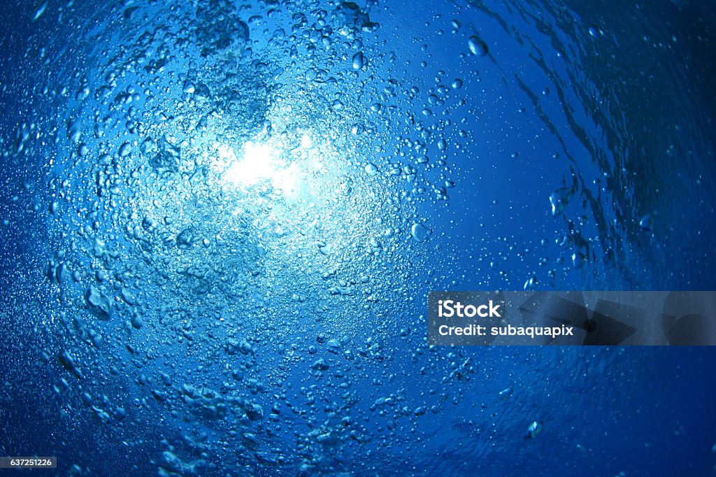 Water surface and bubbles Water surface with bubbles and sunlight in the ocean Adventure Stock Photo
