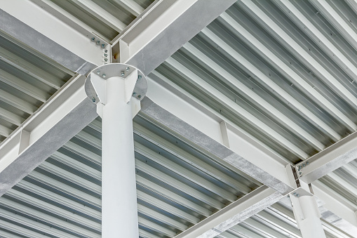 View from below on new ceiling; pillars with steel joints are painted in white.