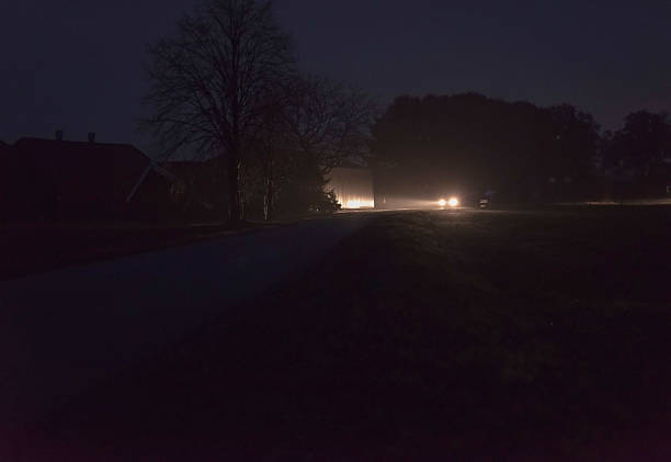 istock Car with headlights driving on rural road at night. 637253910