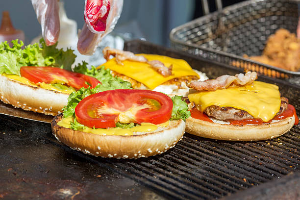 istock hamburgers being grilled with flames 637254492