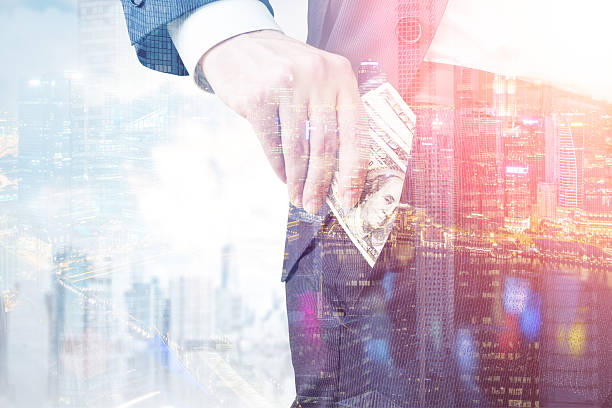 istock Close up of man putting dollars into his pocket 637255154