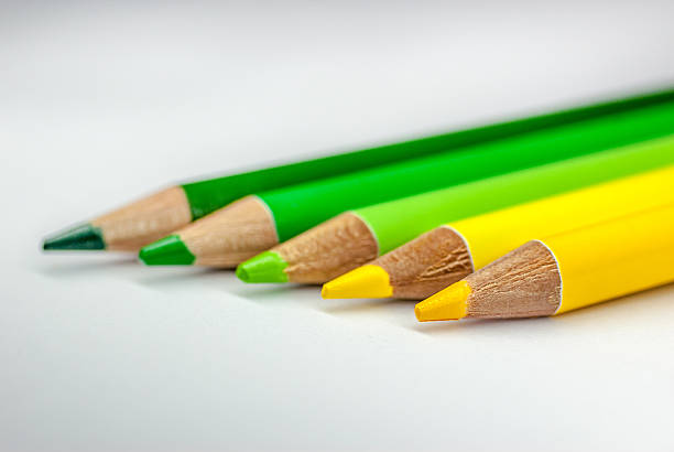 istock Yellow to green coloured pencils isolated on white background 637256396