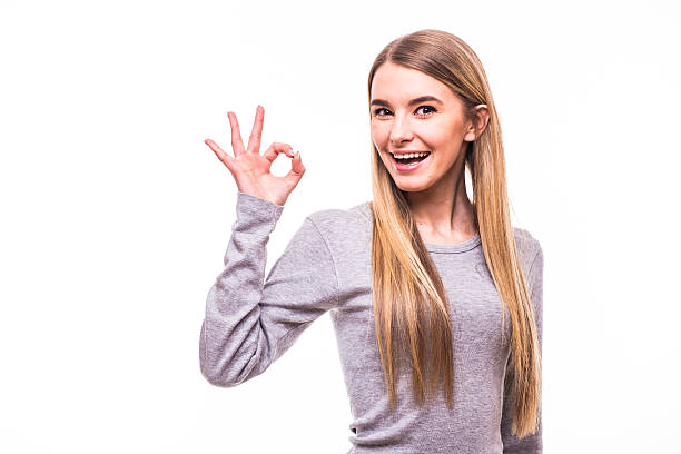 istock Young blonde girl with okay gesture on white background 637256558