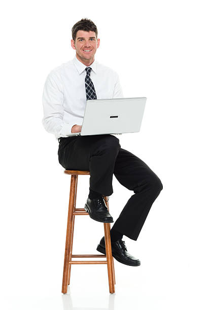 istock Smiling businessman working on laptop 637257360
