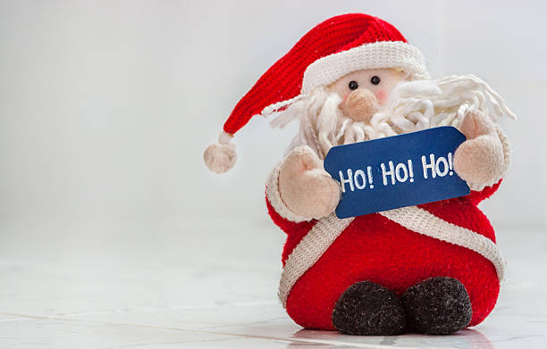 istock Santa Claus toy holding a hohoho sign 637257364