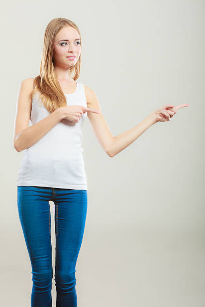 istock woman casual style pointing copy space text area 637258014