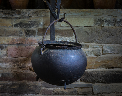 The old and ancient cauldron in a farmhouse.