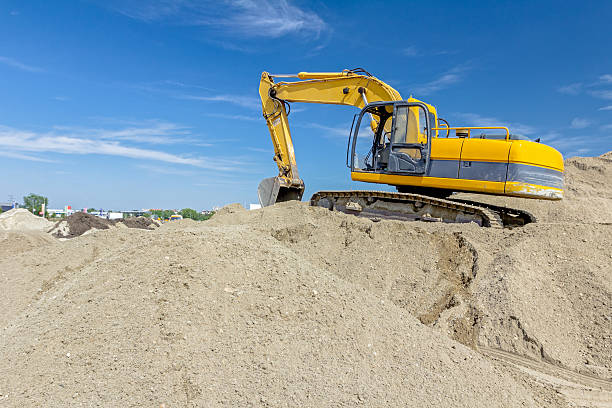 istock Excavator is preparing pile of sand for loading in truck. 637260672