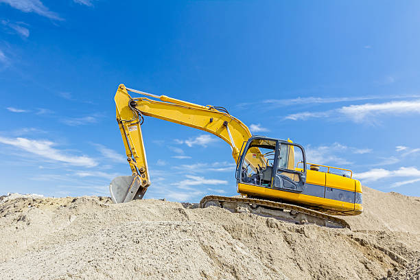 istock Excavator is preparing pile of sand for loading in truck. 637260850
