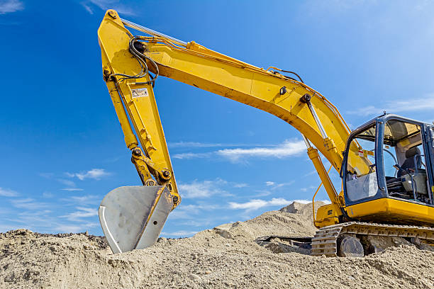 istock Excavator is preparing pile of sand for loading in truck. 637260940