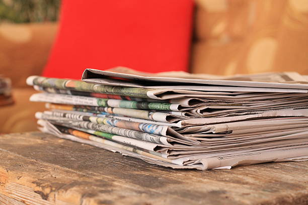 istock Newspapers on wooden table 637261182