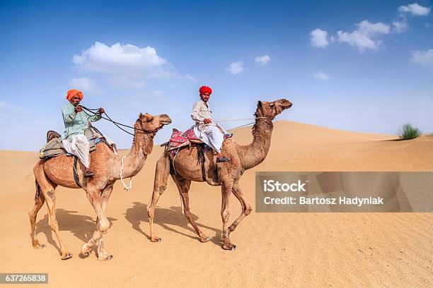 Indian Men Riding Camels On Sand Dunes Rajasthan India Stock Photo - Download Image Now