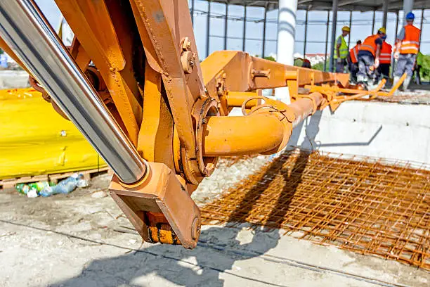 Photo of Detail of mechanical joint at crane's arm. Concrete transport.