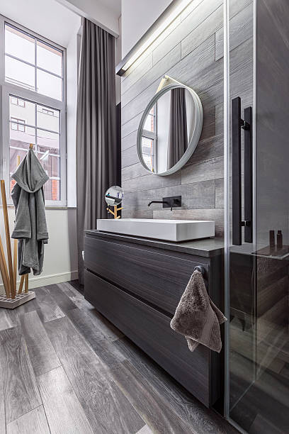 istock Wooden bathroom with round mirror 637267714
