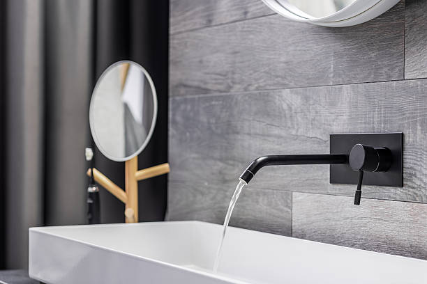 lavabasina com torneira montada na parede - bathroom black faucet - fotografias e filmes do acervo