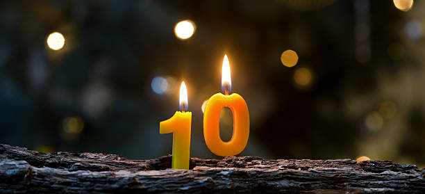 Ten years Birthday candles glowing against sparkling background funkeln stock pictures, royalty-free photos & images