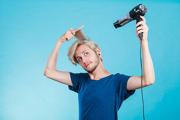 istock Trendy man with hair dryer 637268624