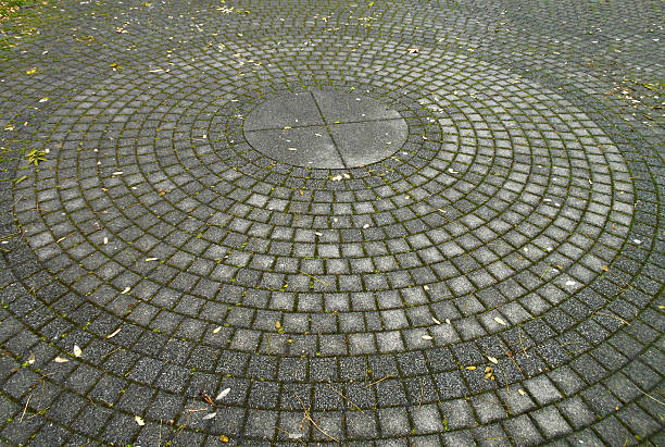 istock Pedestrian walkway made of cobblestones arranged in a circle 637269496