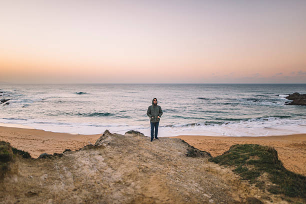 istock Young man, arms raised, at the sea 637270100