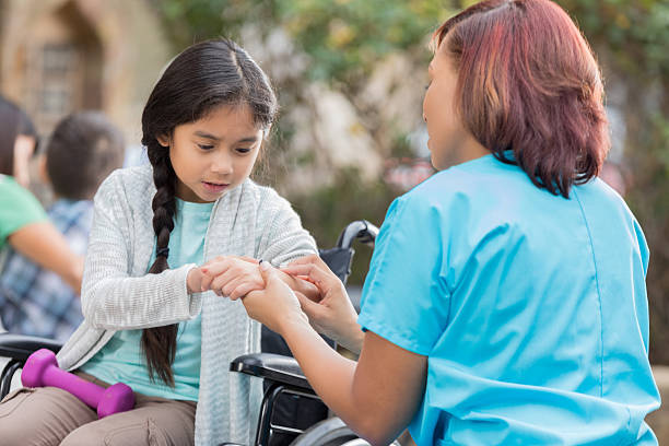 istock Doctor or physical therapist examines young girl 637271416