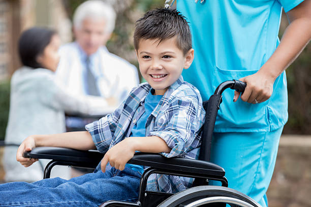 Boy In Wheelchair With Nurse Stock Photos, Pictures & Royalty-Free ...