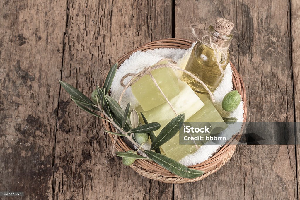 natural olive oil soap bars and olive oil on table natural olive oil soap bars and olive oil bottle in a basket on wooden table Olive - Fruit Stock Photo