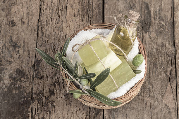 natural olive oil soap bars and olive oil on table stock photo