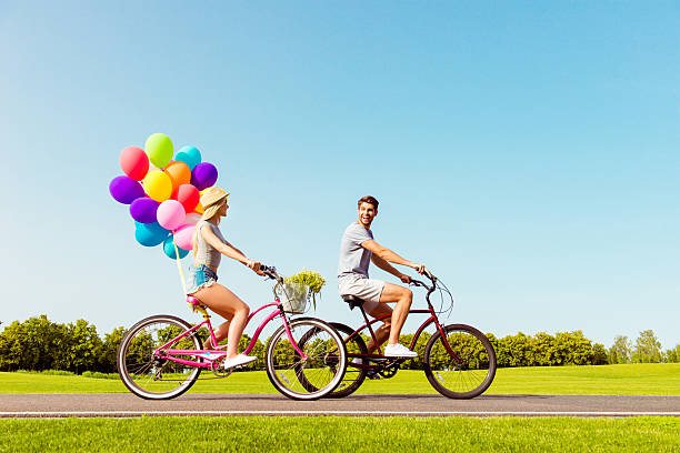 Young happy couple enjoy BMX riding at the skatepark.