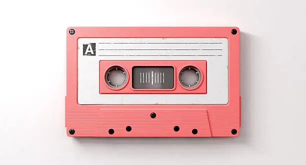 A close up view of a pink vintage audio cassette tape with a white label that reads mix tape on an isolated white background