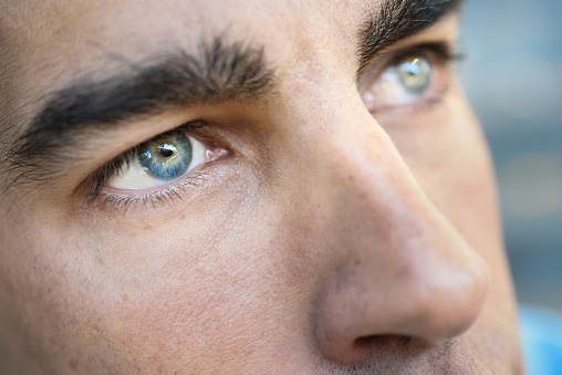 Close-up shot of man's eye. Man with blue eyes.