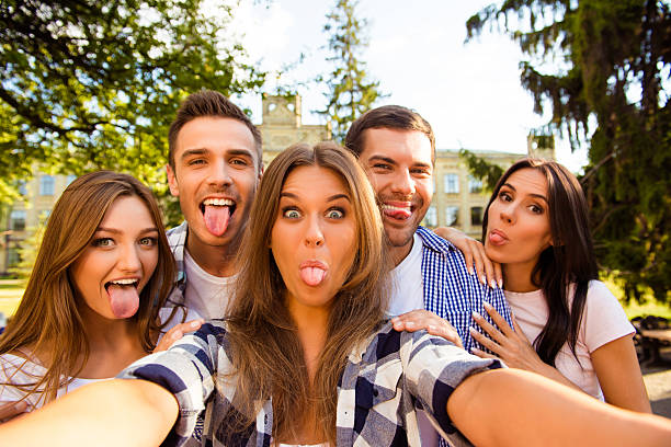 istock five crazy best friends fooling around and making selfie photo 637275376