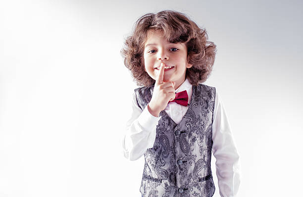 istock Funny curly-haired boy shows a hand gesture, 