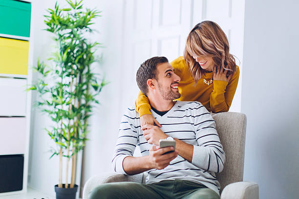 istock Happy couple social networking at home 637277536