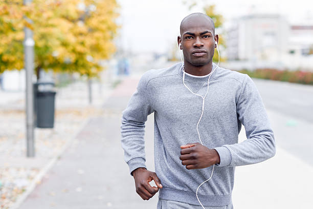 istock Attractive black man running in urban background 637278240