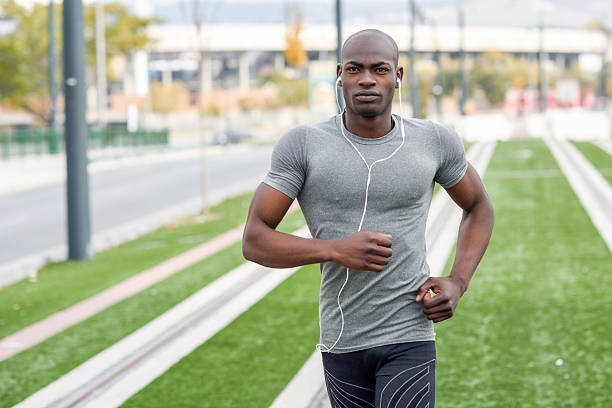 istock Attractive black man running in urban background 637278558