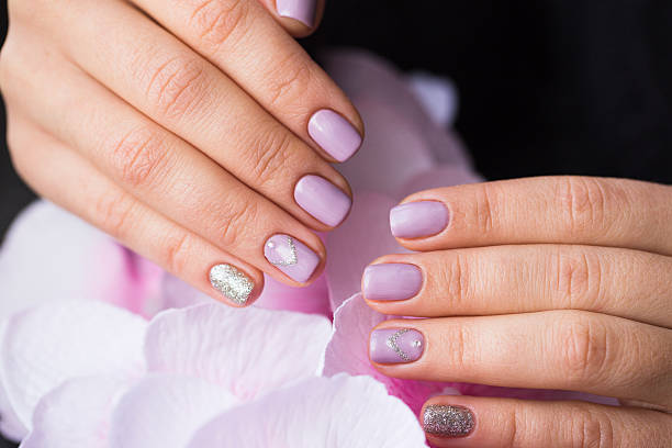 istock Hand with manicured nails on a pink background flowers 637278778