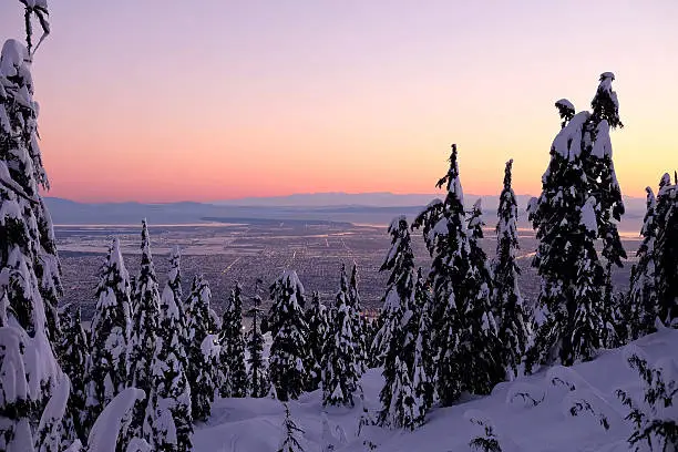 Photo of Winter city view from mountain in sunrise.