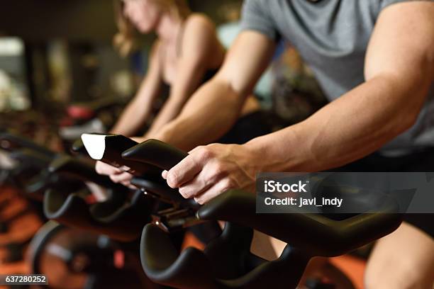 Couple In A Exercising Class Wearing Sportswear Stock Photo - Download Image Now - Spinning, Cycling, Exercising