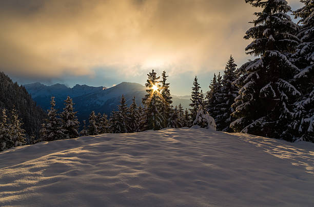 Winter scene with sunset in mountains