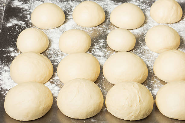 istock Finished dough in the bakery, on steel table. Working process 637280846