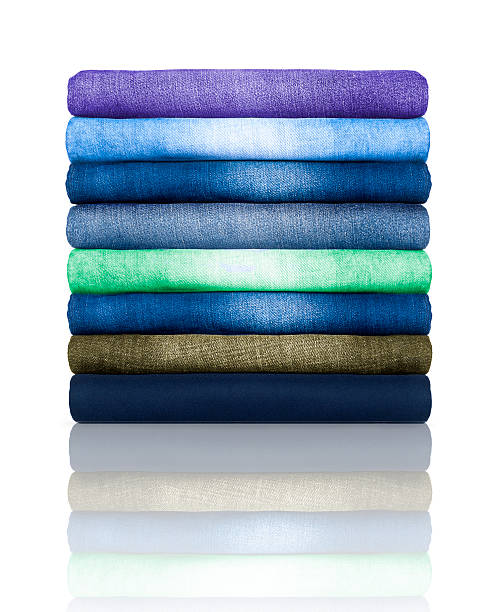 istock pile of colored jeans on a white background 637282302