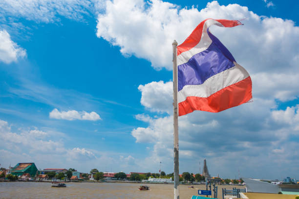 istock Thailand flag blowing in the wind above the river 637284926