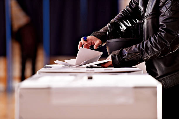 Hands with a stamp casting a vote stock photo