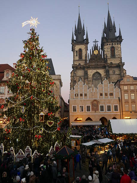 Beautiful christmas tree at Prague old town square Prague, Сzech Republic - December 29, 2016: Tourists and locals visiting the old town square christmas market in Prague, Czech Republic.. prague christmas market stock pictures, royalty-free photos & images