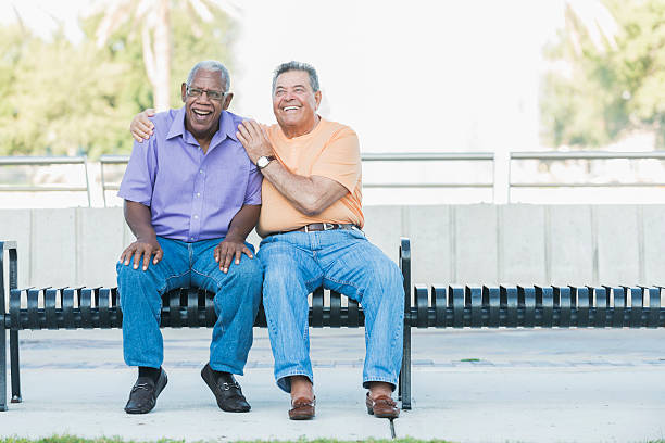 Multi-ethnic senior men hanging out on park bench