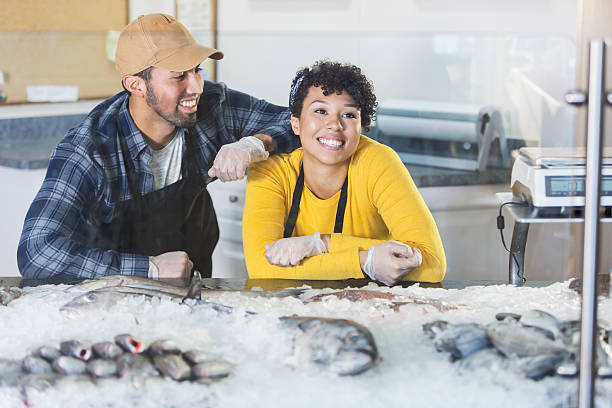 istock Young mixed race couple working in fish market 637288916