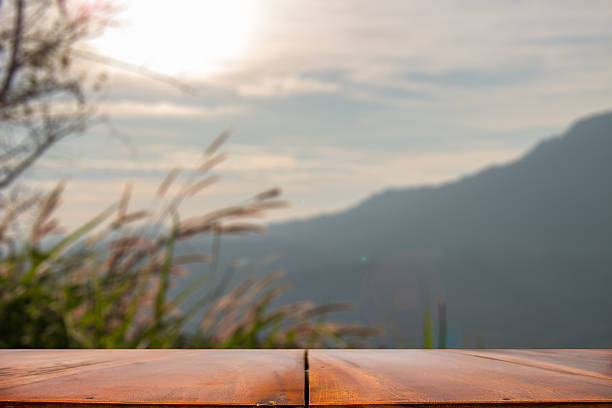 istock wooden table or counter and sunny,mountain blurred 637289184