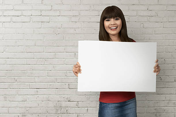 istock Beautiful woman holding a blank billboard 637290840